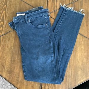 Levi’s 711 dark wash jeans with frayed hem